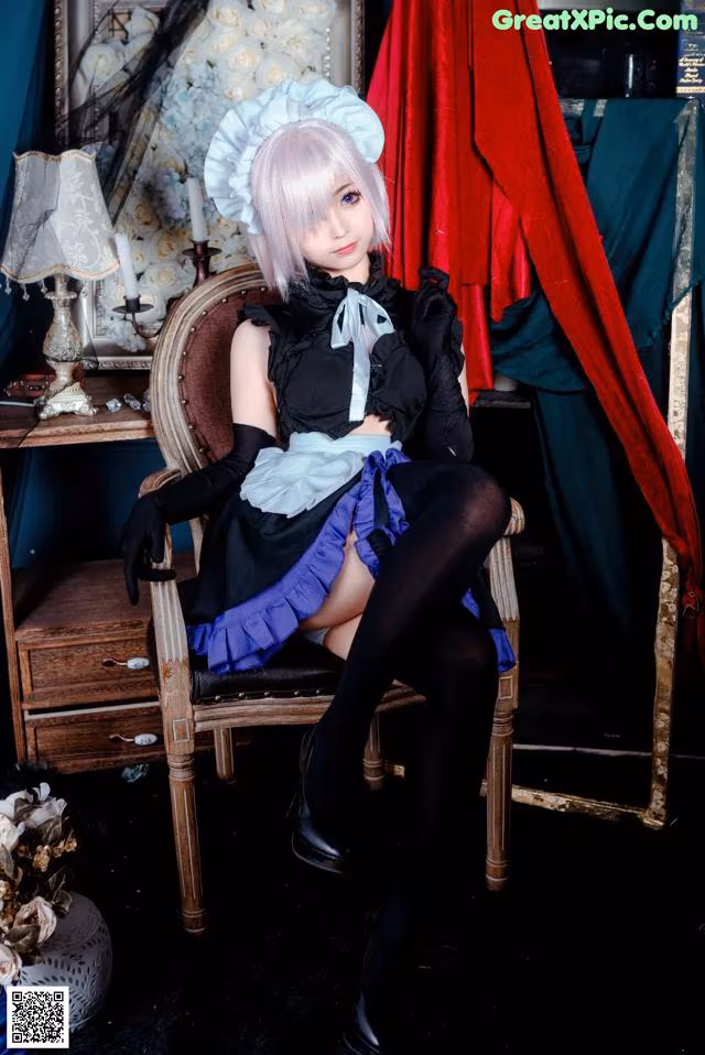 A woman sitting on a chair in a room.