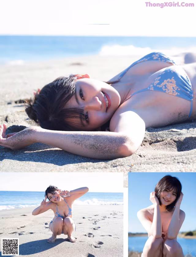 A woman in a blue bikini laying on the beach.
