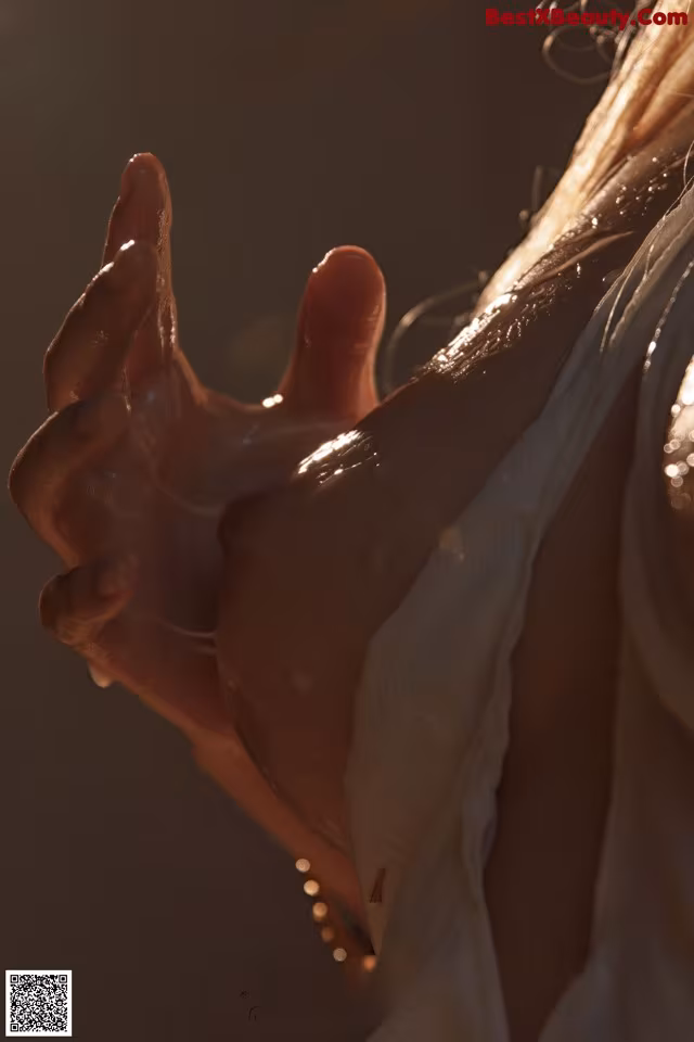 A close up of a woman's hand with water droplets on it.