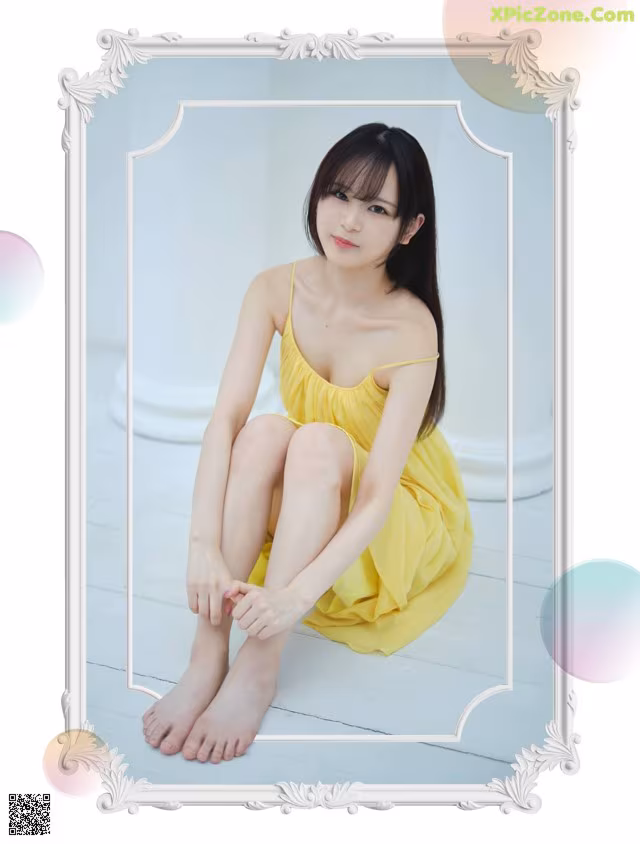 A woman in a yellow dress sitting on the floor.