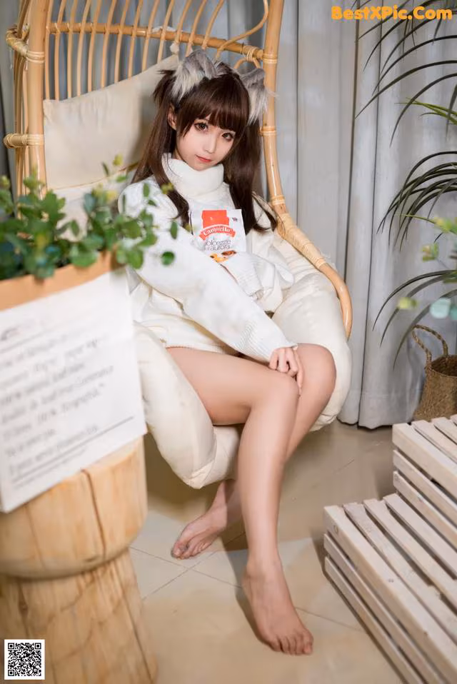A woman sitting on a chair in a room.