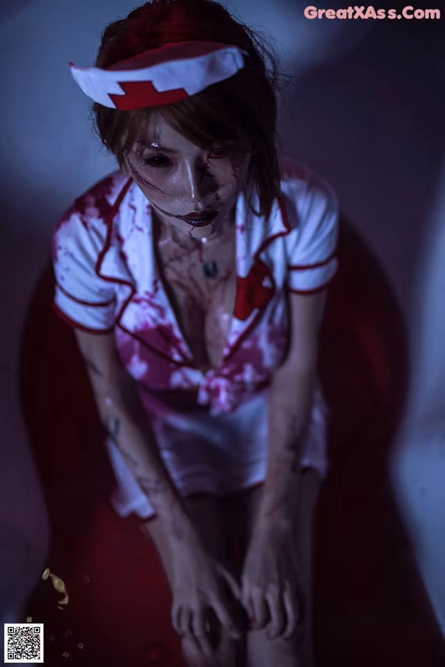 A woman dressed as a nurse with blood on her face.