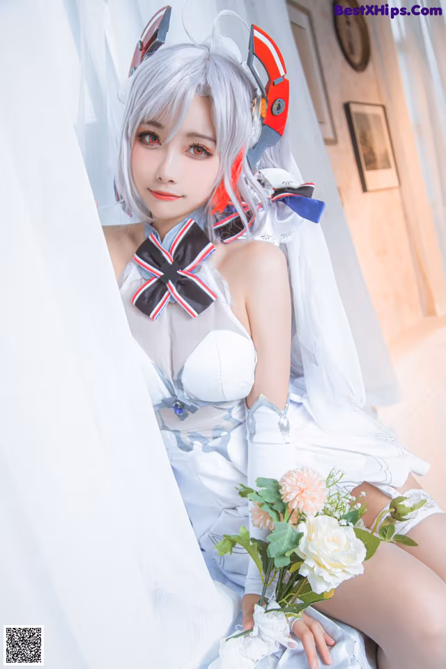 A woman in a white dress holding a bouquet of flowers.