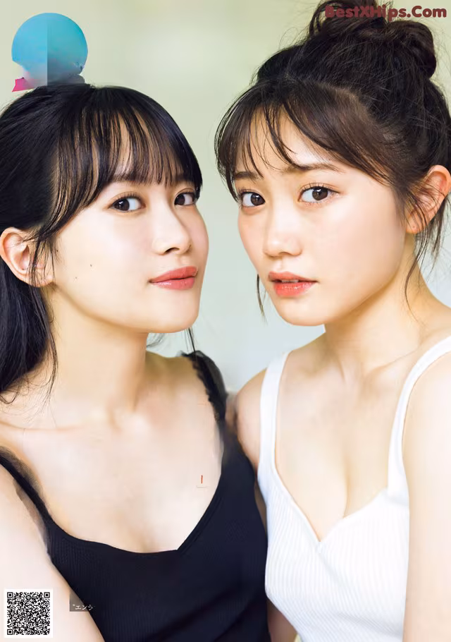 A couple of young women standing next to each other.