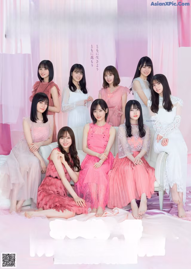 A group of women sitting on top of a bed.