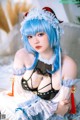 A woman with blue hair wearing a maid outfit.