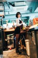 A woman standing in a kitchen next to a counter.