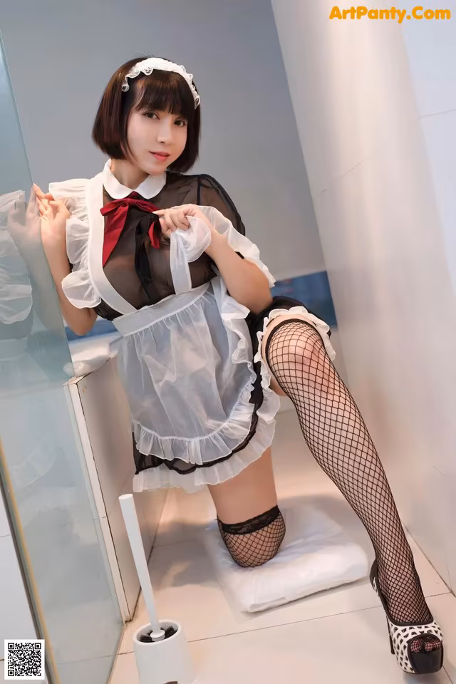 A woman in a maid outfit is posing for a picture.